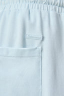 Close-up of light blue athletic shorts with elastic waistband and back pocket detail