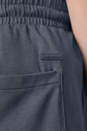 Close-up of granite grey boys' athletic shorts with elastic waistband and side pocket