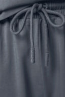 Close-up of dark grey girls' athleisure shorts with drawstring detail and elastic waistband