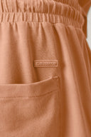 Close-up of mocha brown boys’ activewear shorts with elastic waistband and side pocket