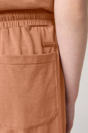 Close-up of mocha brown girls' shorts with elastic waist and back pocket detail