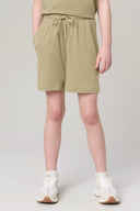 Girl wearing light green athleisure shorts with elastic waistband and drawstring