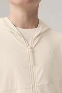 Close-up of child wearing sand-colored kids UV hoodie with zipper and subtle pattern