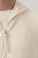 Closeup of sand-colored kids UV hoodie with zipper and subtle textured fabric
