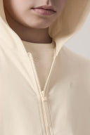 Close-up of a child wearing a sand-colored kids UV hoodie with zipper detail