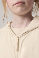 Close-up of a girl wearing a sand-colored kids UV protection hoodie with front zipper