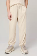 Kids sand jogger pants with elastic cuffs and drawstring waist, worn with sneakers