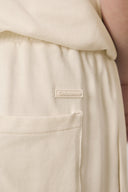 Close-up of sand beige kids jogger pants with side pocket and elastic waistband