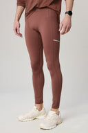Sepia brown men's athletic tights with reflective stripe and white sneakers