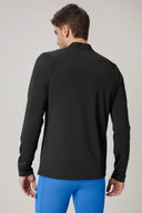 Back view of man wearing charcoal fitted athletic jacket and bright blue leggings