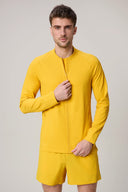 Man wearing a fitted yellow athleisure jacket and matching shorts, front view
