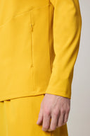 Close-up of yellow fitted jacket with zip pocket and matching yellow pants