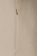 Close-up of beige performance jacket pocket with discreet zipper detail