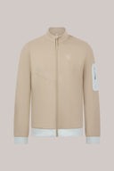 Clay beige athletic jacket with front zipper, white sleeve pocket, and white hem accents