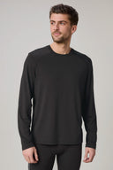 Man wearing a charcoal long sleeve active tee, athletic fit, against plain background