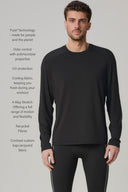 Man wearing charcoal long sleeve performance tee and black athletic leggings, standing indoors.