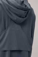 Closeup of grey long sleeve performance hoodie with textured back panel and hood