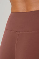 Close-up of high-waisted sepia leggings with smooth waistband and visible seam detail