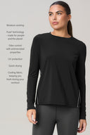 Woman wearing charcoal long sleeve athletic shirt and leggings, features listed on left