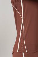 Close-up of sepia long sleeve activewear top with mesh ventilation panels and white trim