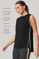 Woman in a sleeveless charcoal tank top with side vent detail and athletic leggings