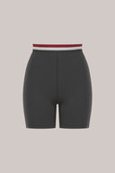Charcoal high-waisted bike shorts with burgundy and white striped waistband, front view