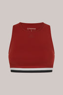 Red high-impact sports bra with wide striped elastic band and scoop neckline, isolated on light background.