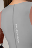 Close-up of back of gray and mauve rashguard with 'Every Move Matters' text on fabric