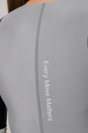 Close-up of gray athletic rashguard with 'Every Move Matters' text on back seam