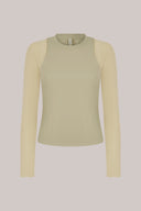 Pale olive green long sleeve active tee with fitted silhouette on plain background