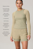 Woman wearing pale olive green long-sleeve active tee and shorts, moisture wicking, quick drying, recycled fabric