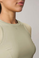 Close-up of woman wearing pale olive performance active tee with crew neckline