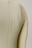 Close-up of pale olive active tee with smooth fabric and visible seam detail