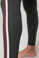 Charcoal athletic leggings with burgundy and white side stripes, close-up on legs